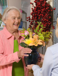 Flowers and a senior woman